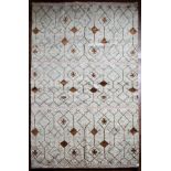 A Moroccan style rug with repeating stylised star pattern within a geometric design across the