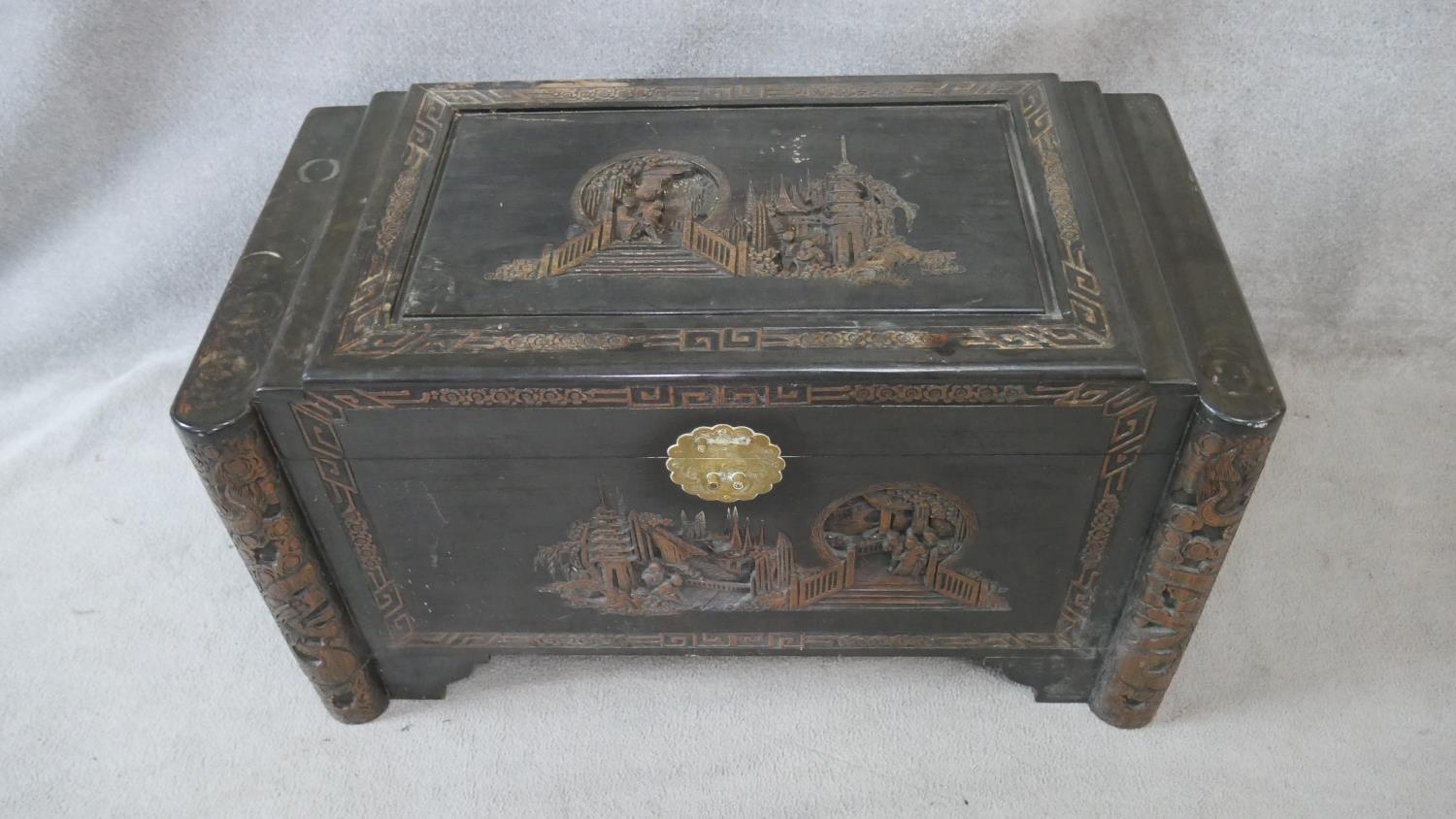 A Chinese camphor coffer with all over carved figural decoration. H.58.5 W.103.5 D.54cm - Image 2 of 9