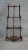 A mahogany four tier corner whatnot with inset leather shelves. H.102 W.51 D.36cm