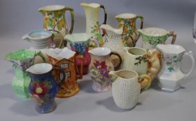 A collection of hand painted Carlton Ware, Royal Doulton, Wade and other vintage ceramic jugs.