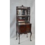 A late 19th century mahogany mirror backed side cabinet with Chinese style pierced shelved upstand