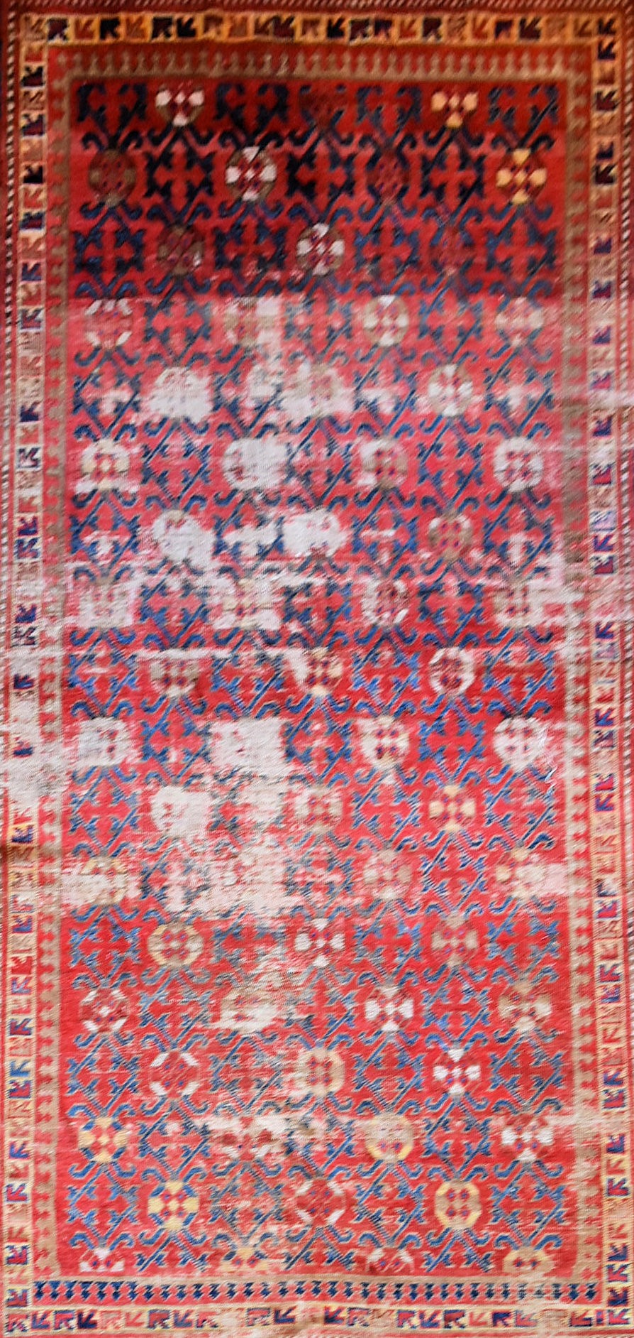 An antique Tabat carpet with repeating gul motifs across the deep red field contained within a - Image 2 of 4