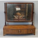 A Georgian mahogany swing mirror with original plate above base fitted with three drawers with ivory