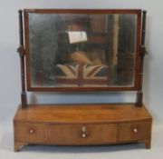 A Georgian mahogany swing mirror with original plate above base fitted with three drawers with ivory