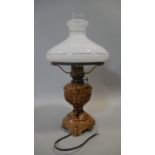 A table lamp with milk glass shade and ceramic base, converted from a 19th century oil lamp. H.52cm