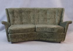 A mid century vintage two seater sofa in buttoned upholstery with maker's label to the underside.