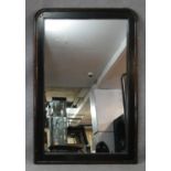 A black lacquered overmantel mirror in faux bamboo style frame. H.120 W.80cm