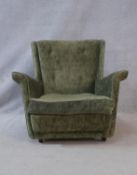 A mid century vintage armchair in buttoned upholstery. H.77 W.78 D.81cm