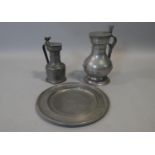 A collection of pewter. Including a lidded flagon with acorn detailing, a large lidded flagon with