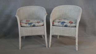 A pair of vintage Lloyd Loom woven tub armchairs with maker's label to the underside. H.68cm