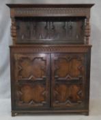 An 18th century country oak court cupboard with stepped moulded cornice and panelled