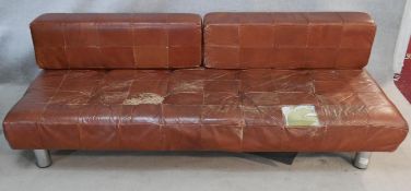 A 1970's vintage sofa in tan upholstery raised on tubular chrome supports with a pair of removable