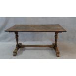 A 19th century country oak style dining table on turned baluster stretchered supports. H.75 L.153