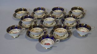 A set of twelve Paragon gilded lace, foliate and cobalt fine bone china cups and saucers, hand