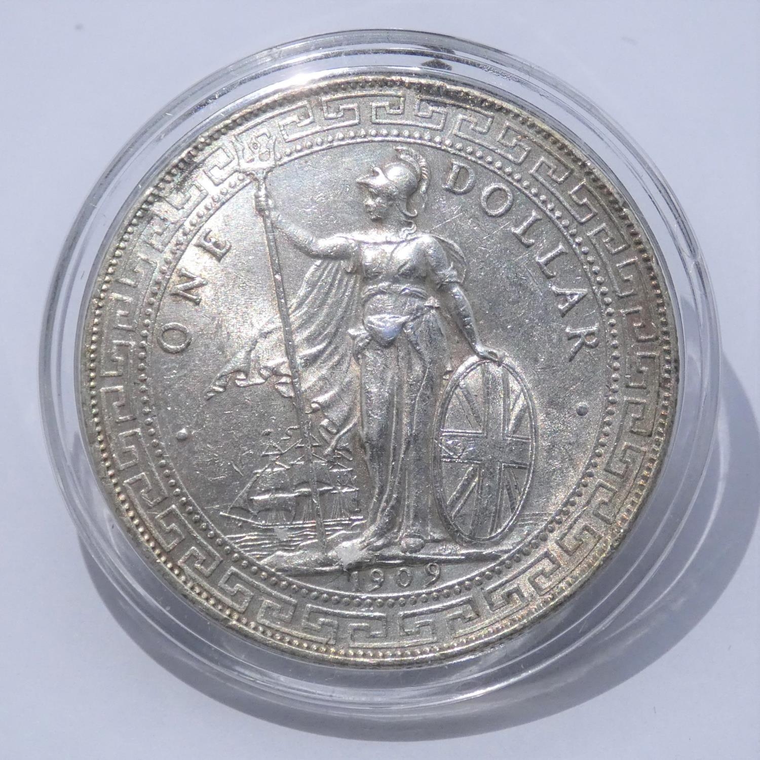 A 1909 Hong Kong silver trading dollar in capsule case. With COA. Weight 28g From a private