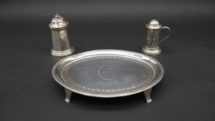 A Georgian oval silver mint tray on four feet with engraved laurel decoration and Greek key design