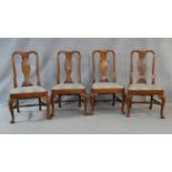 A set of four Queen Anne style fruitwood dining chairs with shaped vase splats above drop in seats