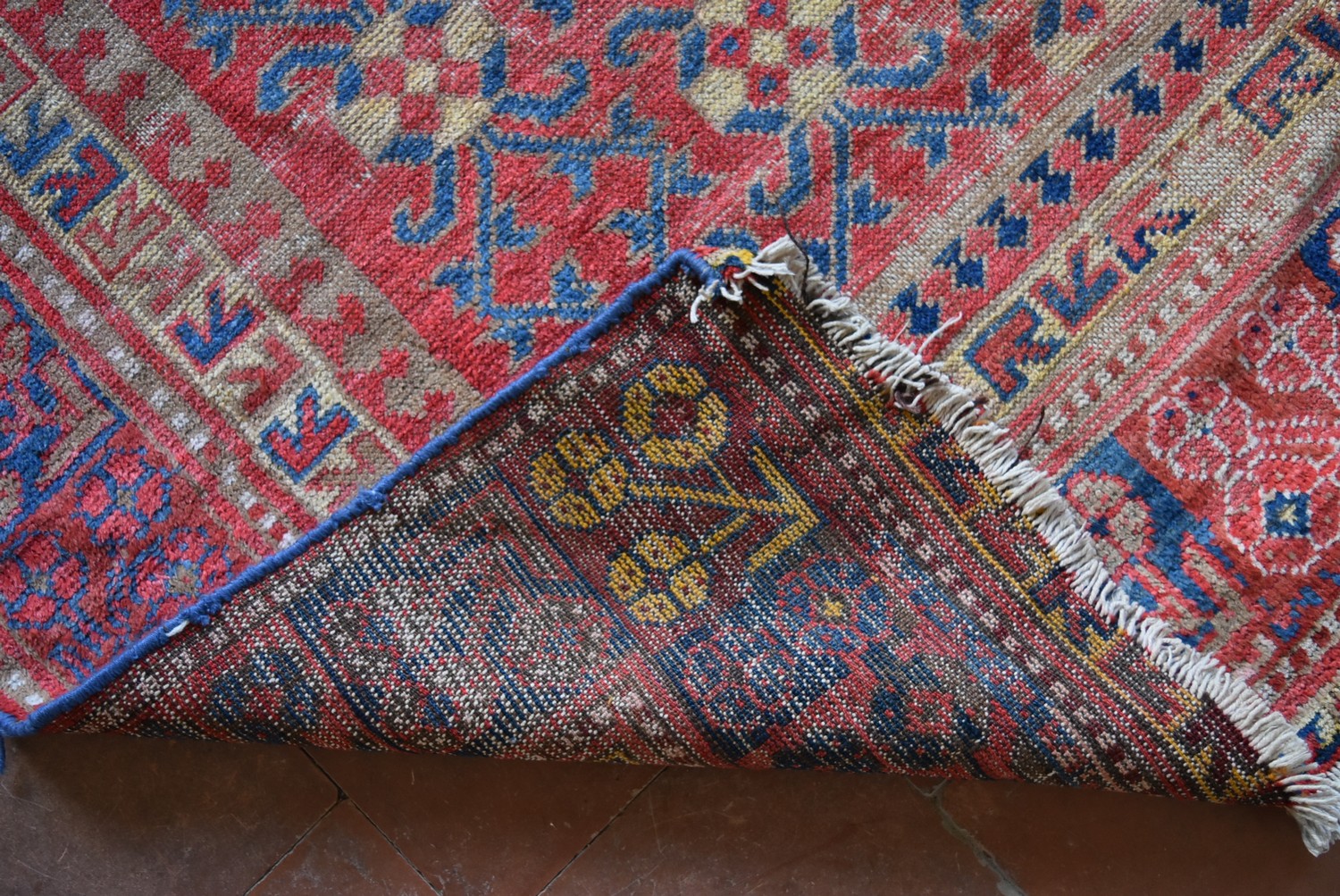 An antique Tabat carpet with repeating gul motifs across the deep red field contained within a - Image 4 of 4