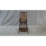 A Victorian beech framed metamorphic child's high chair with fold down tray converting to play