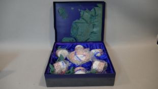 A boxed Crown Staffordshire Ellesmere coffee set for six, one saucer broken, otherwise as new in