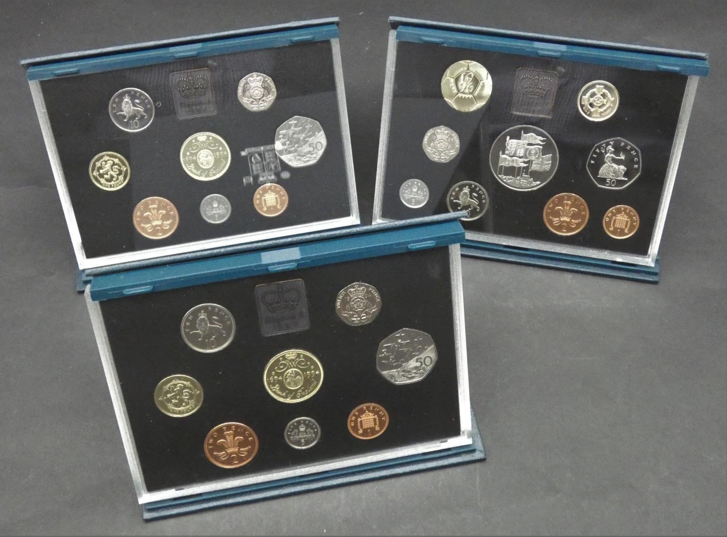 A collection of three sets of proof coins. Including a 1996 Royal Mint Proof et including the