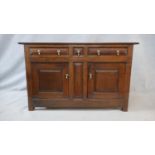 A 18th century French Provincial oak side cabinet with pair of frieze drawers and central narrow