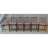 A set of six mid century oak slat back dining chairs on square chamfered supports. H.79cm