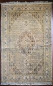 A silk & wool Tabriz style carpet with central medallion and repeating floral design across the fawn