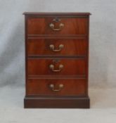 A Georgian style mahogany filing cabinet with inset leather top above dummy drawers enclosing two