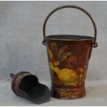 A metal coal bucket and scoop with brass handles and lacquered collage decoration. H.65cm