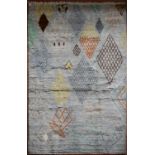 A Moroccan style rug with abstract diamond patterns across a powder blue ground. L.245xW.170cm