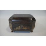 A Georgian jappaned lacquered lidded box with hand gilded and painted decoration on carved gilt wood