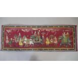 An Indian painting on silk, a Royal procession within a floral border. H.34 W.100cm