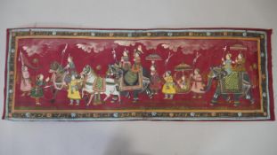 An Indian painting on silk, a Royal procession within a floral border. H.34 W.100cm