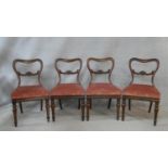 A set of four mid 19th century rosewood dining chairs with shaped backs above drop in seats on