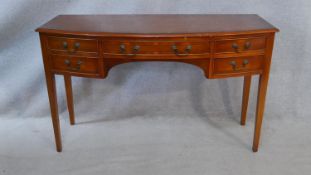 A Georgian style yew and crossbanded writing table with an arrangement of five drawers on square