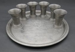 A vintage pewter tray and six matching beakers bearing the Touring Club of Switzerland crest with