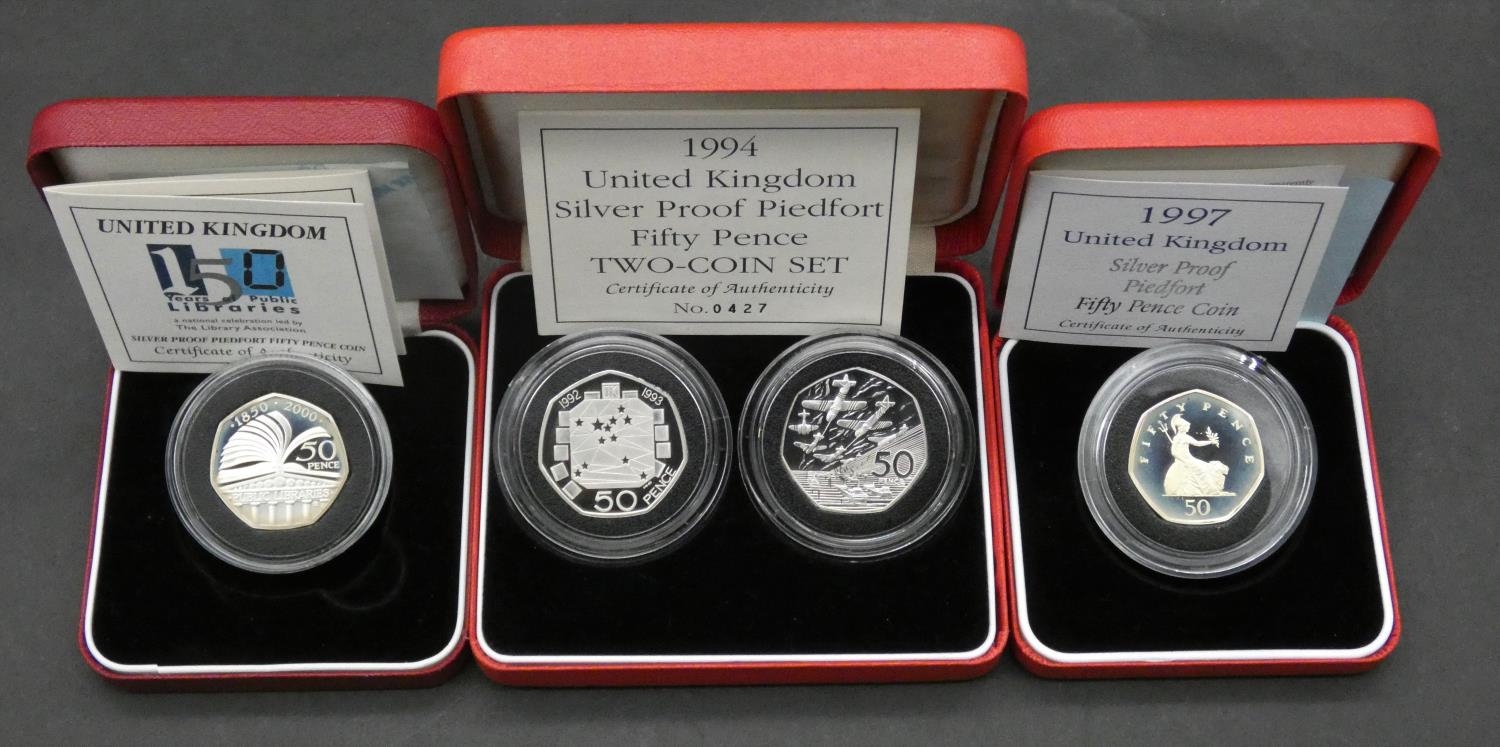 Four Royal Mint piedfort silver proof 50 pence coins. Including a UK 150 years Public Library silver