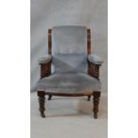 A 19th century mahogany framed armchair in buttoned upholstery on turned tapering supports. H.95 W.