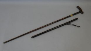 An antique leather swagger spear stick along with a 19th century harwood walking cane with brass