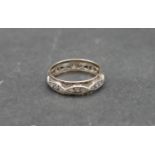 An antique white metal and yellow metal eternity band set with hand cut white stones. With shaped