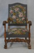 A C.1900 carved oak throne chair in the Carolean style in floral tapestry upholstery on turned