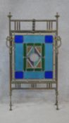 A 19th century brass fire screen with coloured leaded glass inset panel. H.87 W.50cm