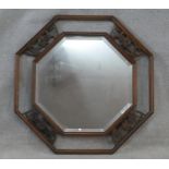 An Eastern teak bevelled plate wall mirror with Chinese bat carvings to the open fretwork frame. H.