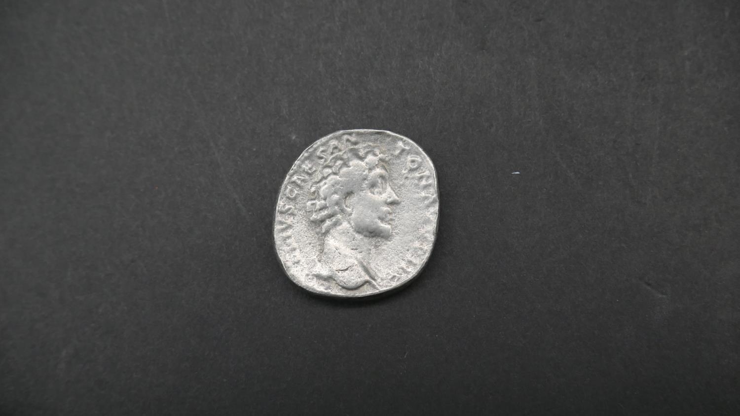 Four ancient Roman coins. Including an ancient roman silver coin depicting Securitas seated on a - Image 3 of 9