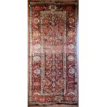 An antique Persian Malayer rug with central lozenge medallion within a broad naturalistic foliate