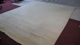 A large 1960's vintage off-white tufted wool carpet. L.340 W.285cm