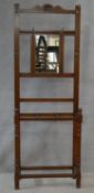 A late 19th century walnut mirror backed hallstand with three section umbrella and stick stand. H.