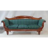 An early Victorian mahogany framed three seat sofa with carved scrolling foliate decoration and