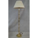 A brass standard lamp on turned column and circular platform base. H.170cm